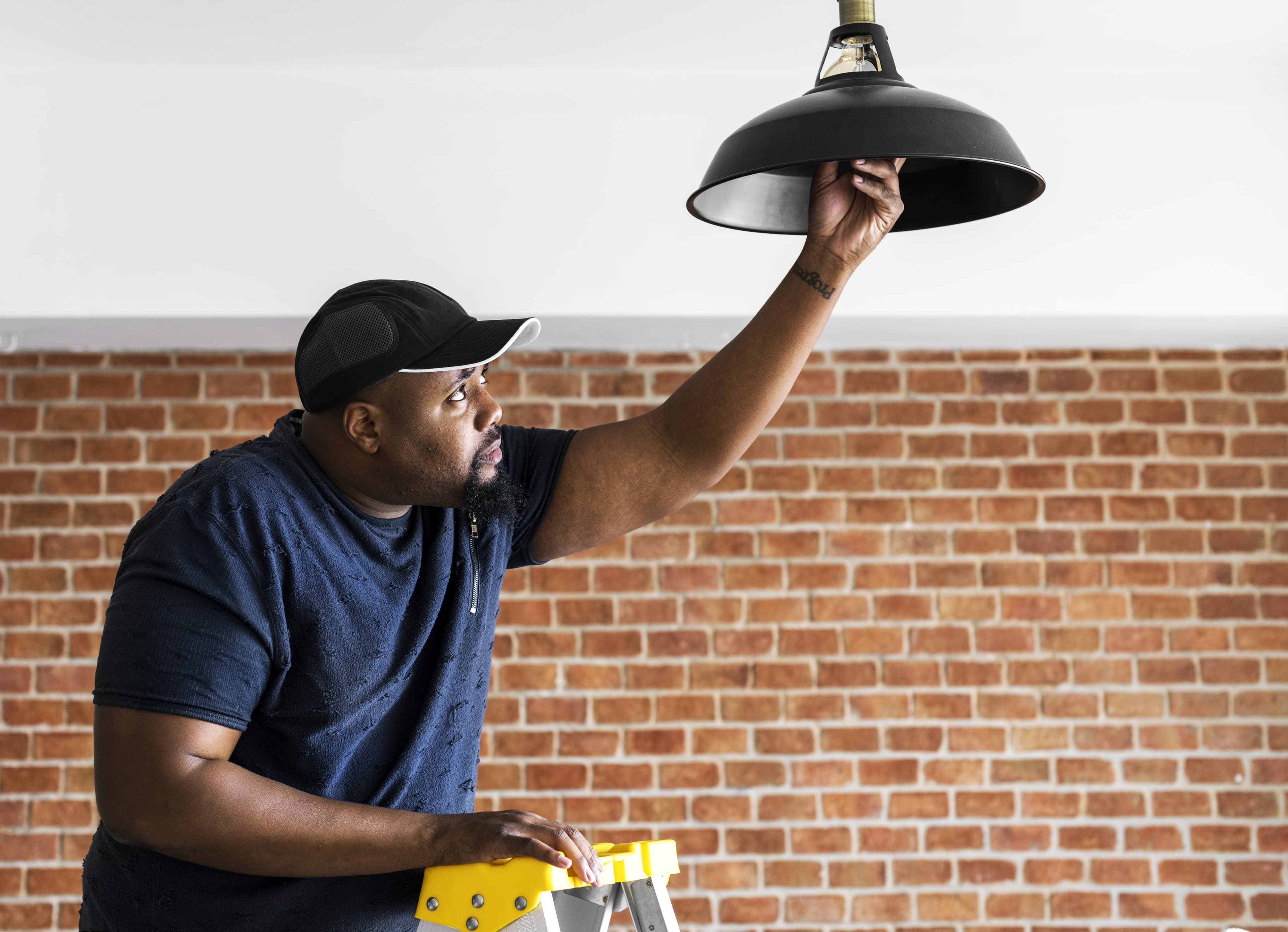 Electrician fixing a light fixture